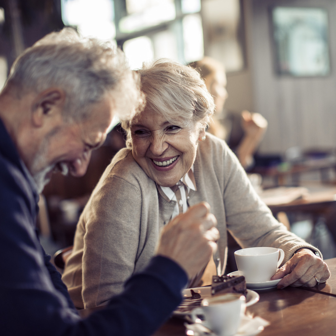 Äldre par som fikar