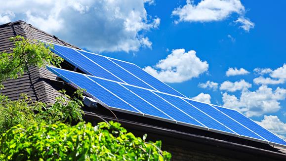 Elektriker monterar ställning för solcellspaneler på ett tak.